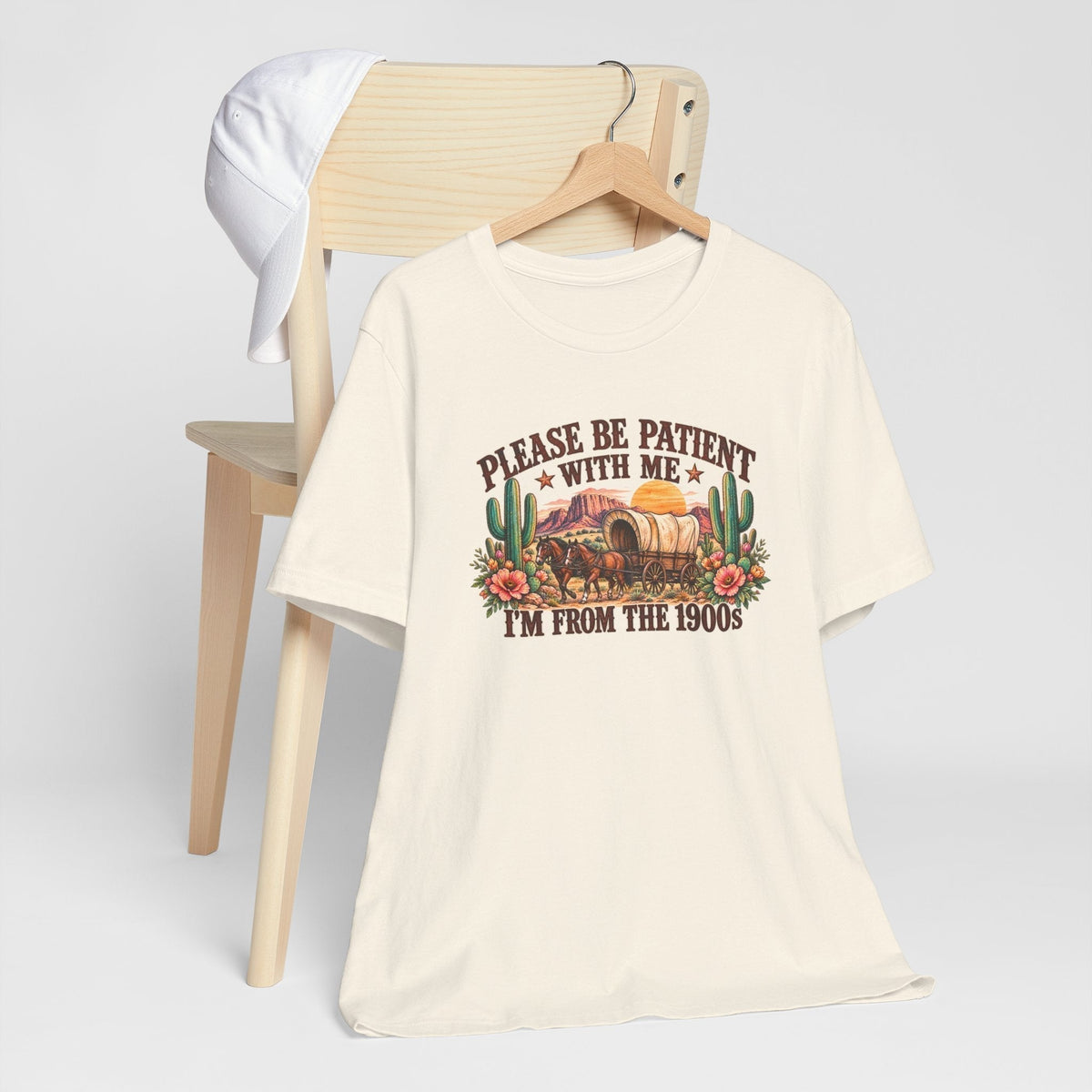 cowgirl graphic tshirt in cream cotton with a colorful vintage wagon, cacti, flowers and humorous western lettering