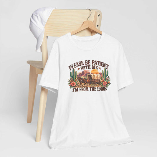 cowgirl graphic tshirt in white cotton with a colorful vintage western wagon, cactus, flowers, and humorous text