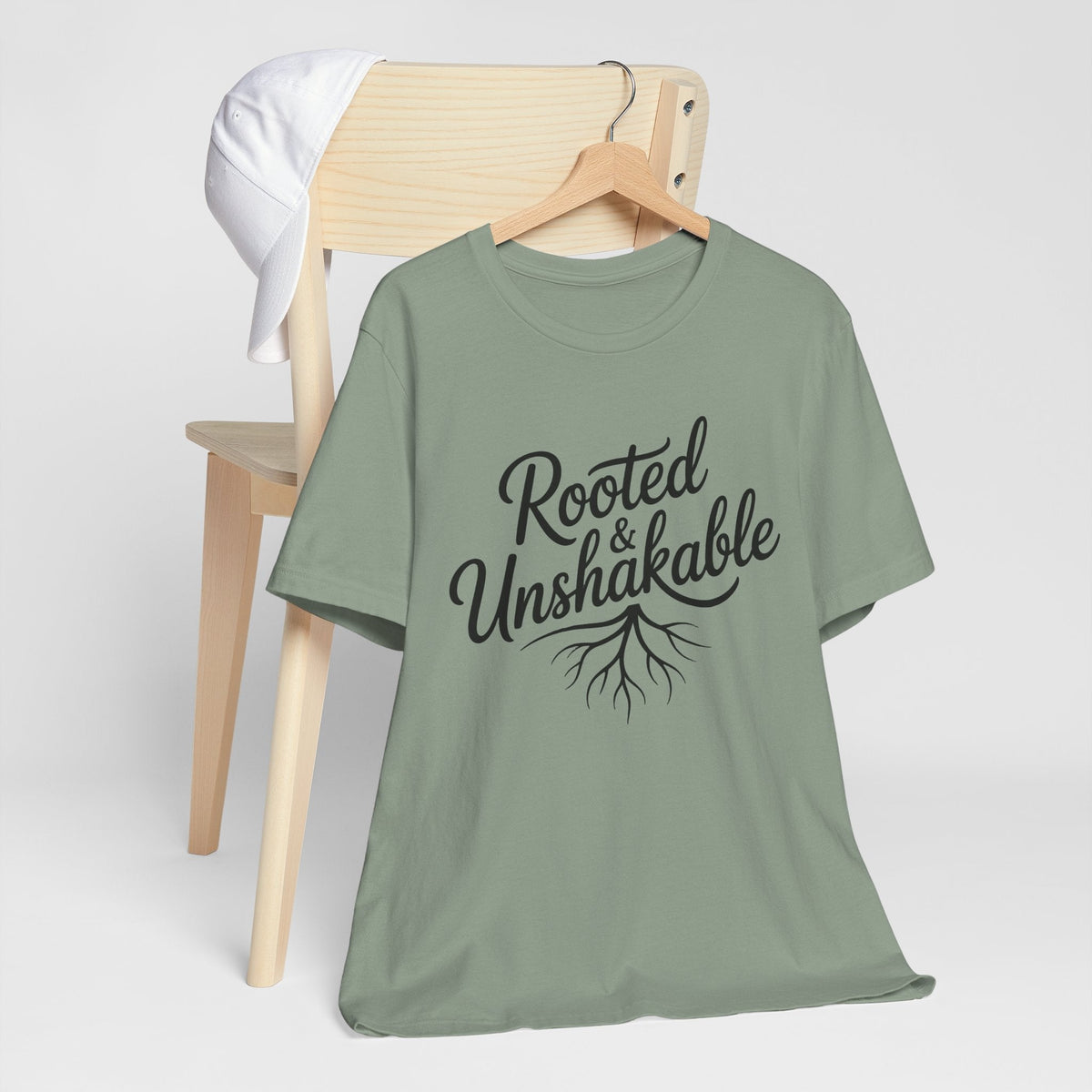 Rooted and Unshakable faith tshirt for ladies in sage green with black script lettering and delicate root graphic