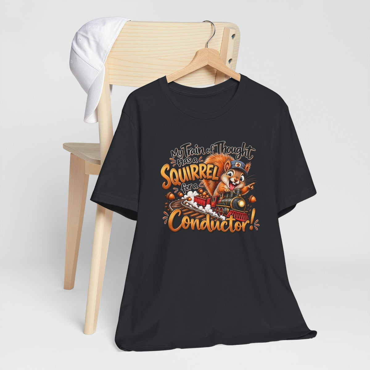 funny animal shirt in black with colorful squirrel conductor and train of thought graphic in orange and white
