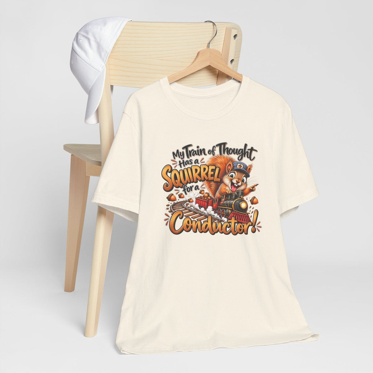 Funny animal shirt in cream cotton with a colorful squirrel conductor and train of thought graphic