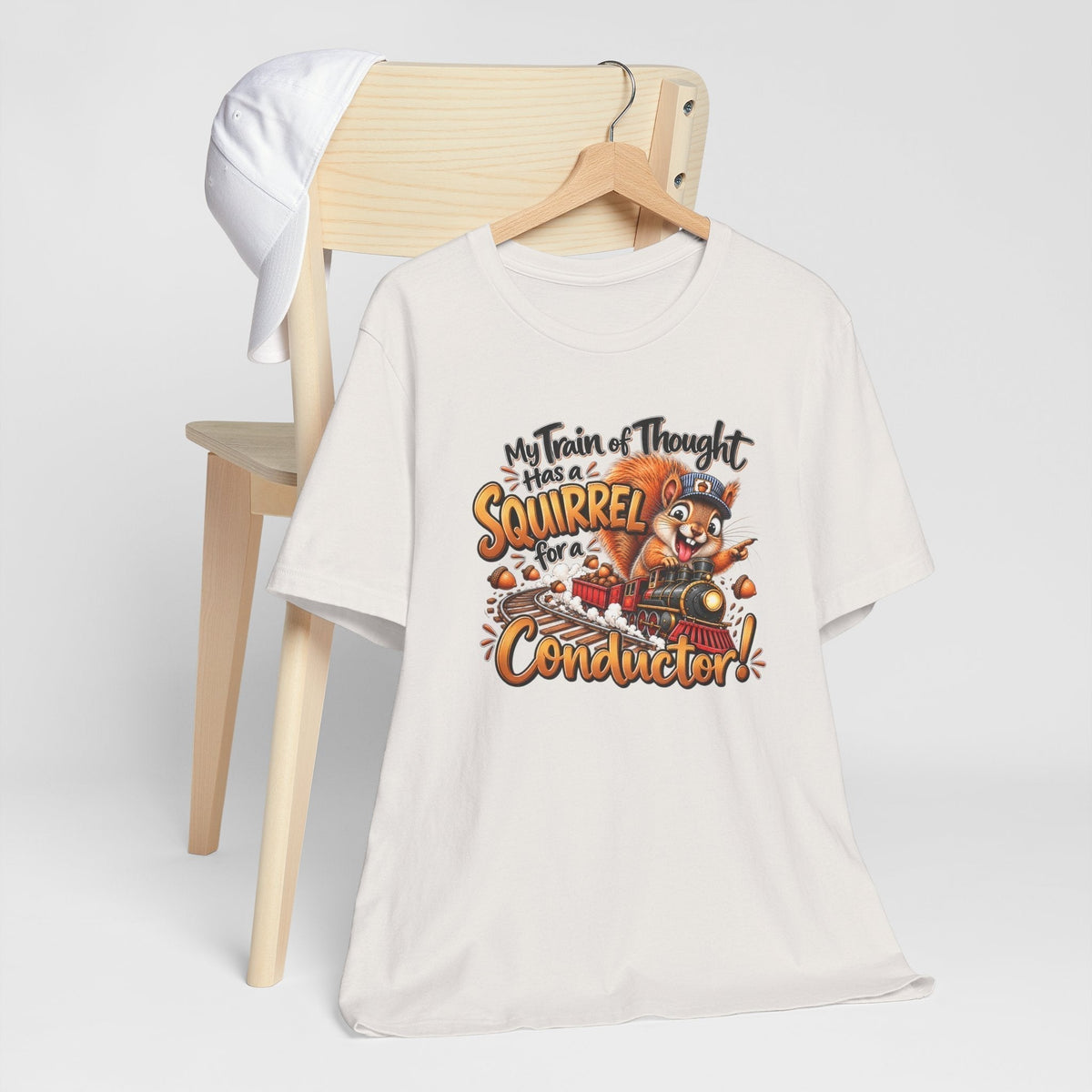 funny animal shirt in ivory with a colorful squirrel conductor riding a train and playful lettering