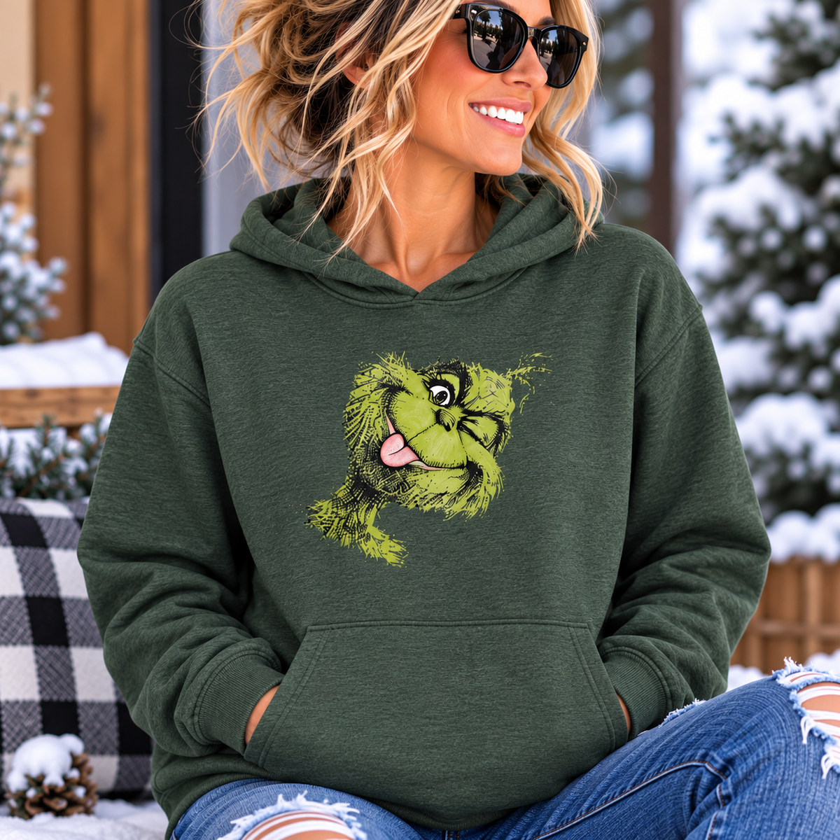 funny christmas hoodie in dark green fleece with a bright green Grinch face graphic, hood and kangaroo pocket