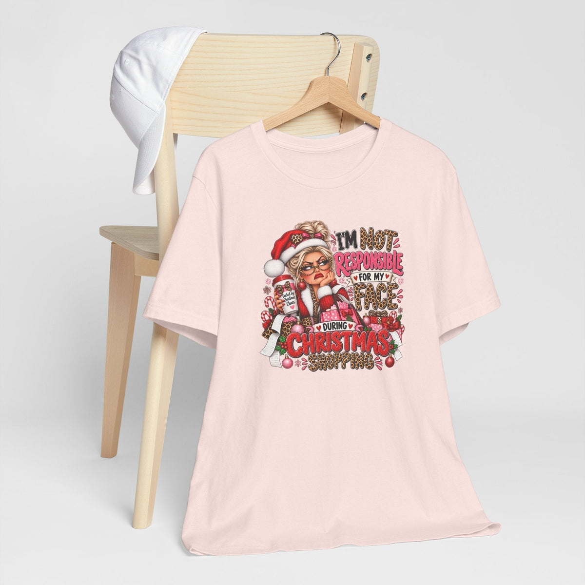 funny christmas shirt in pale pink cotton with a colorful Santa shopper graphic and bold festive lettering