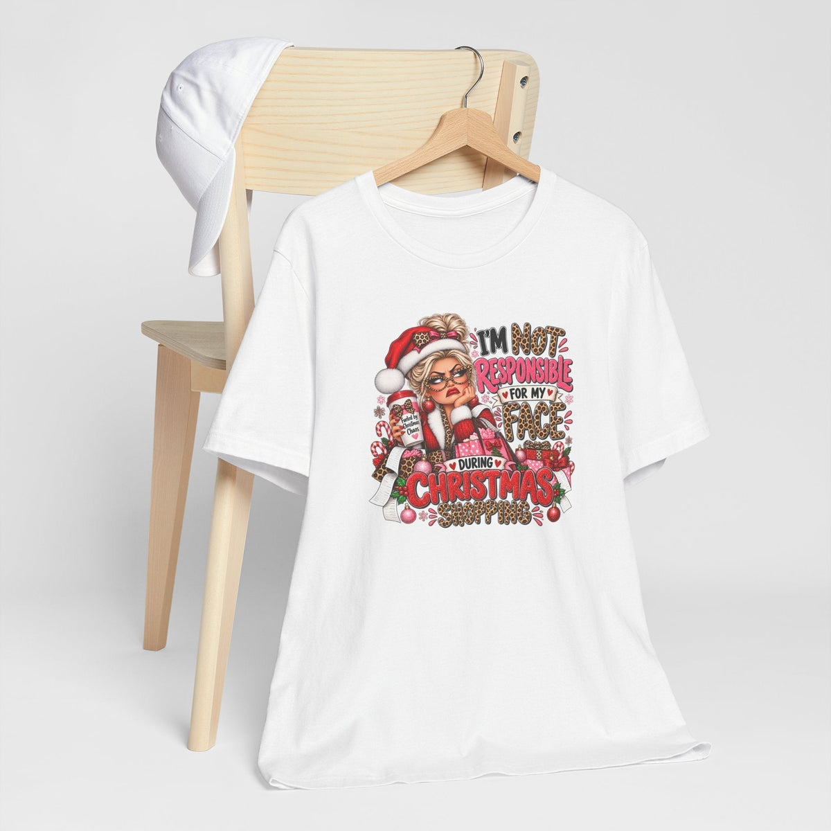 funny christmas shirt in white cotton with a colorful Christmas shopping graphic, leopard print lettering, and festive details