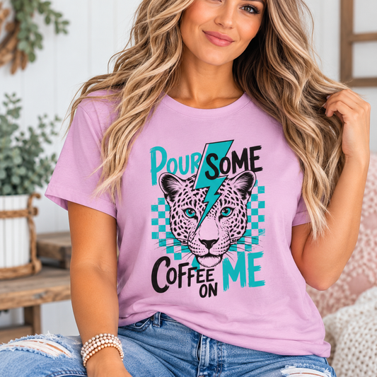 Funny coffee shirt in lilac cotton with a bold leopard face, teal checkerboard and “Pour Some Coffee On Me” graphic