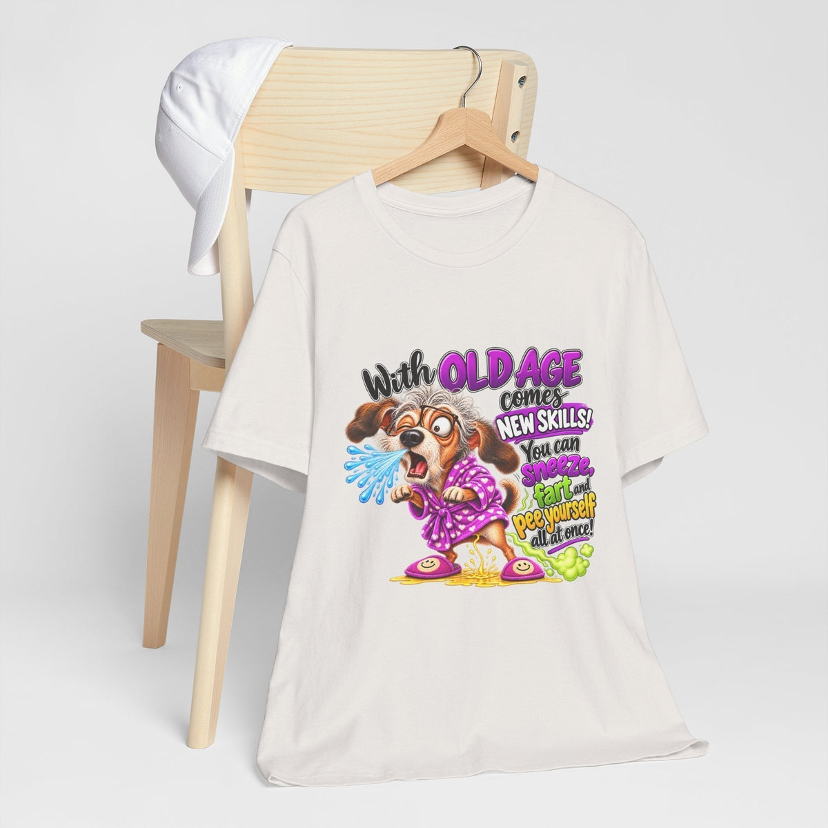 Funny old age tshirt in white cotton with a colorful frazzled dog graphic and playful aging-skills lettering