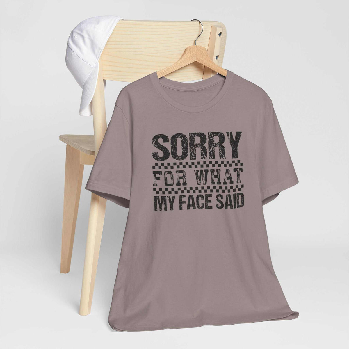 Funny tshirt for women in muted mauve with a black distressed graphic reading “Sorry for what my face said.”