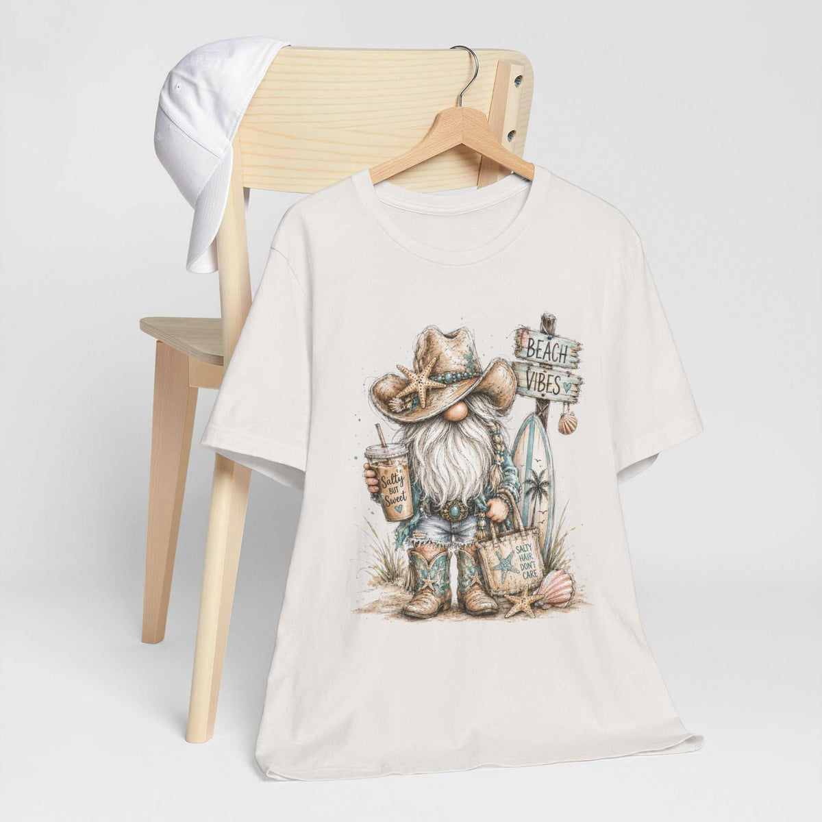 gnome t shirts featuring an off-white cotton tee with a watercolor beach gnome in a starfish hat and coastal accents