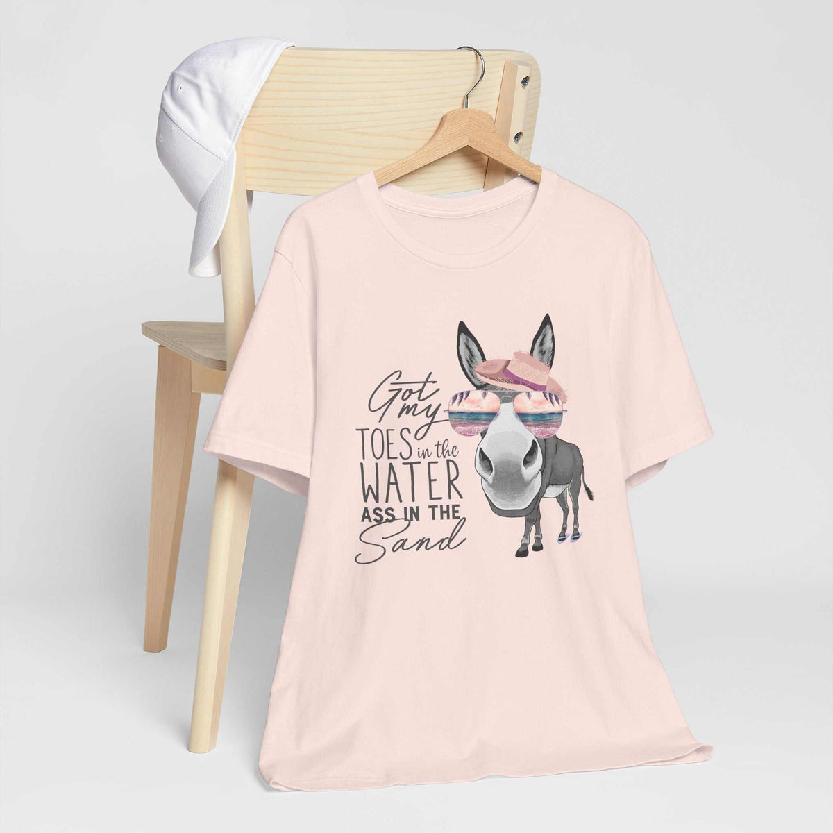 Got My Toes in the Water tee in pale pink with a cheeky donkey wearing a pink hat and sunglasses graphic