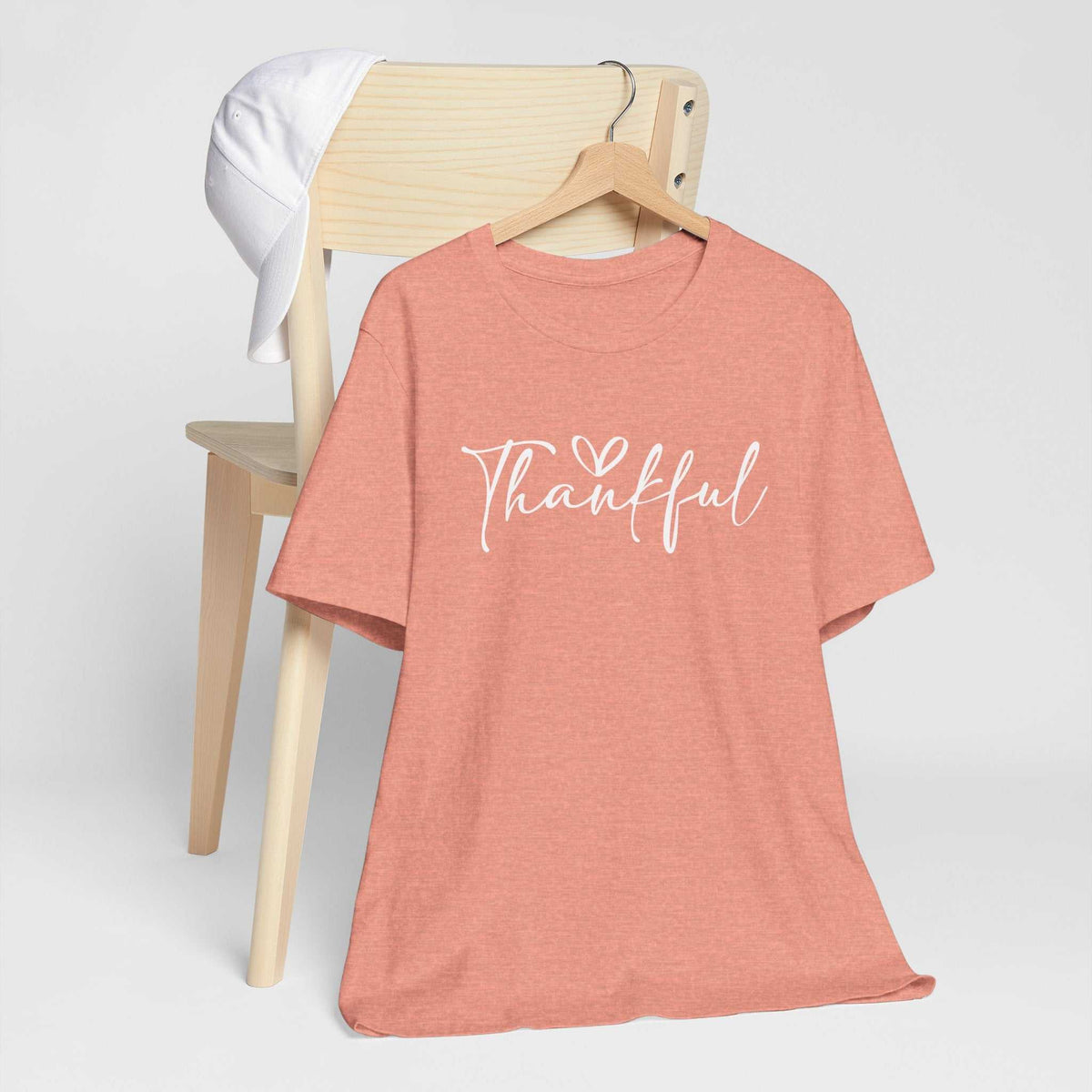 Gratitude tshirt in heather clay with a white handwritten “Thankful” graphic and heart on a short-sleeve tee