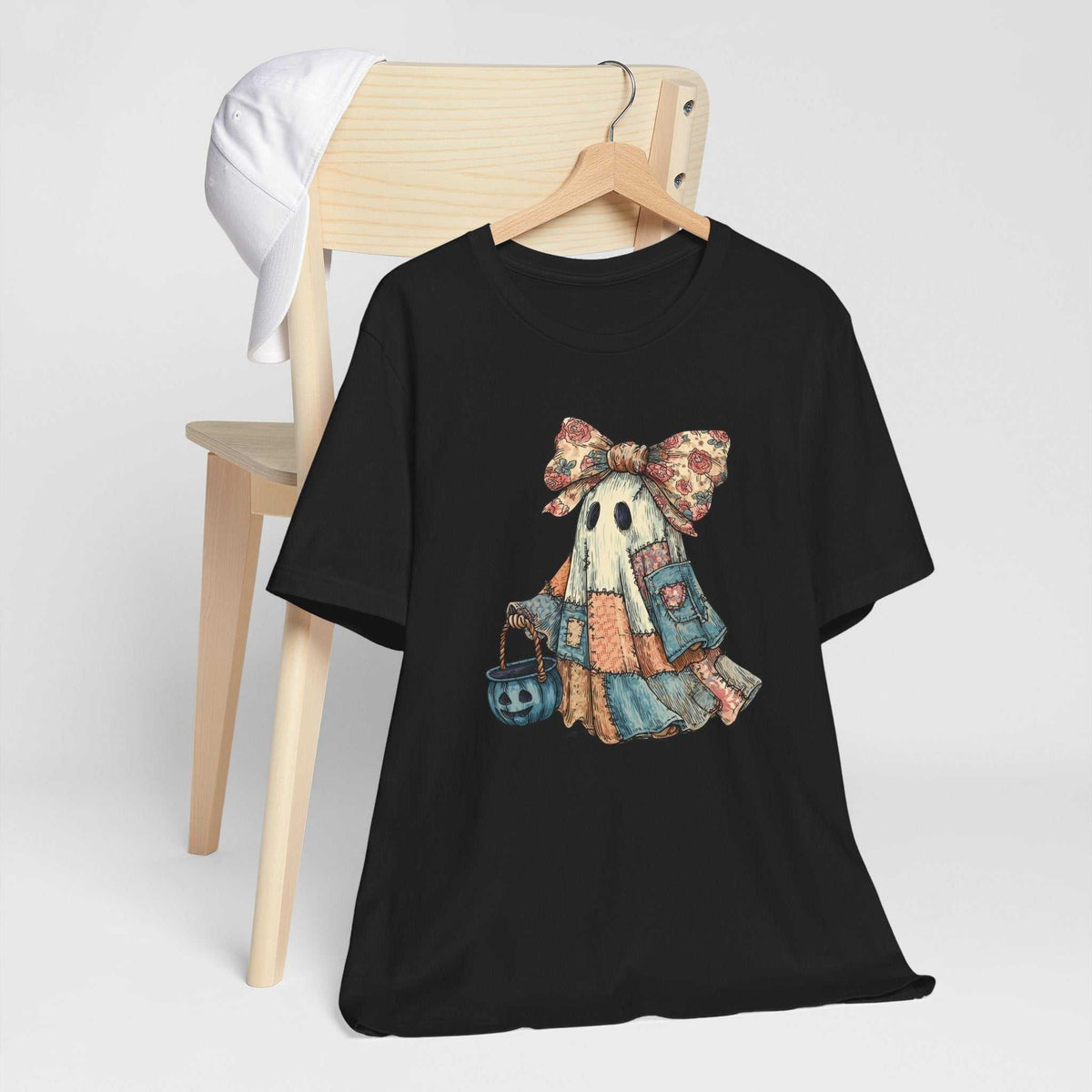 Halloween Ghost Tshirt in black cotton, featuring a vintage-style ghost in a patchwork dress, floral bow and pumpkin bucket