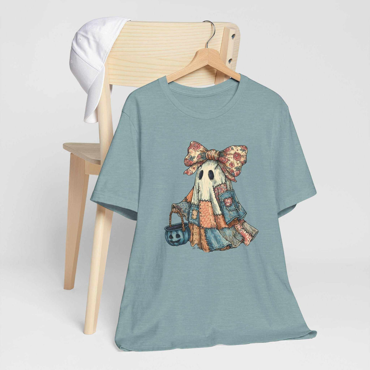 Halloween Ghost Tshirt in muted blue cotton with a vintage patchwork ghost wearing a floral bow and carrying a pumpkin pail