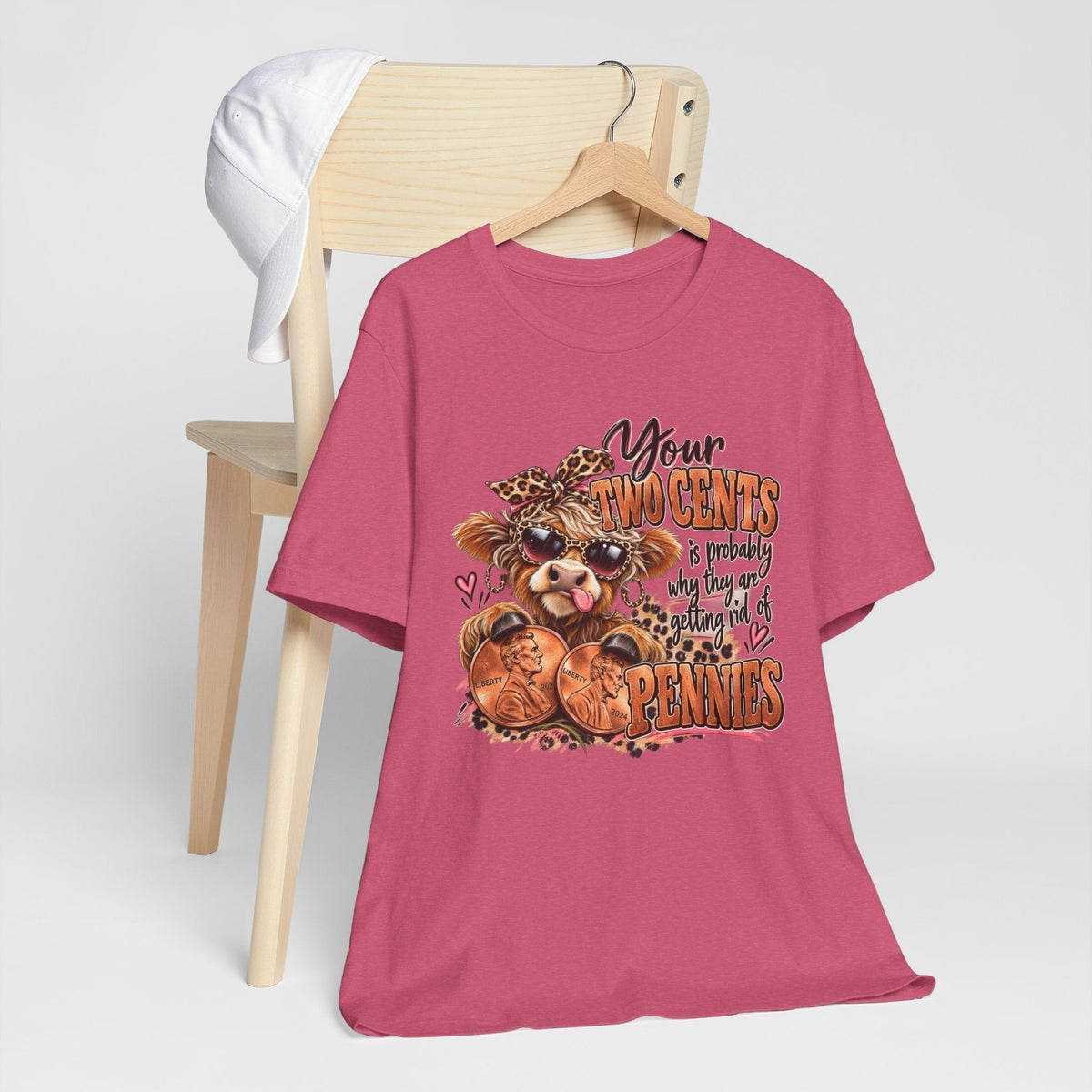 Highland cow funny graphic tee in rose pink cotton, featuring a shaggy cow, pennies and a cheeky money-themed slogan