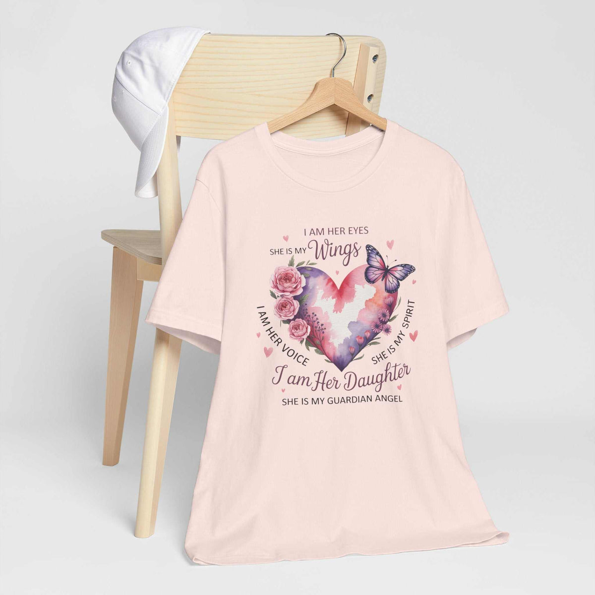I Am Her Daughter memorial T-shirt in pale pink with a watercolor heart, roses, butterflies, and guardian angel message