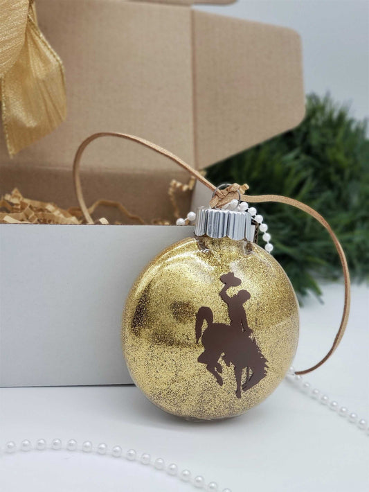 Wyoming Cowboy Ornament with gold glitter and brown steamboat design, University of Wyoming themed.