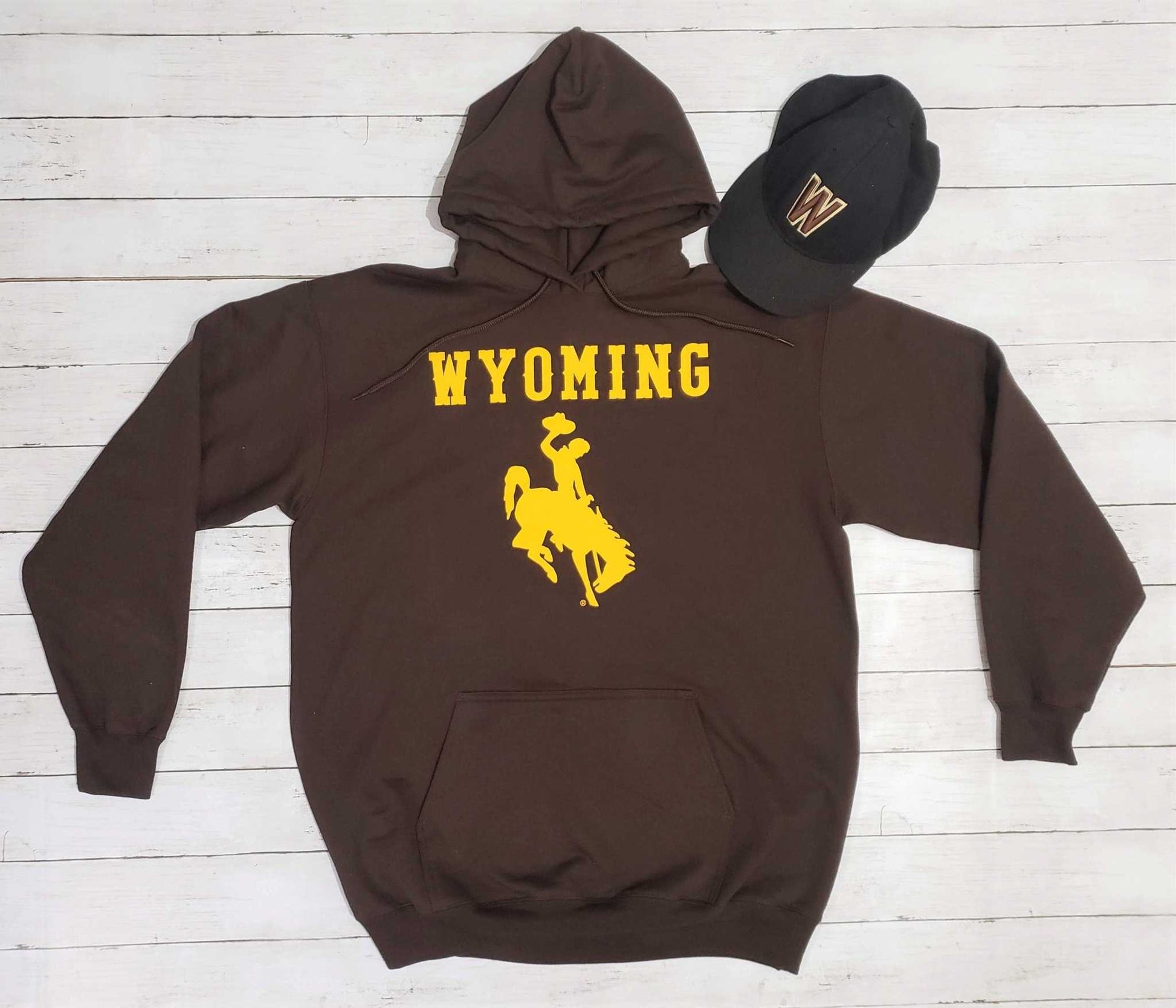 University of Wyoming brown hoodie with yellow bucking horse logo and Wyoming text.
