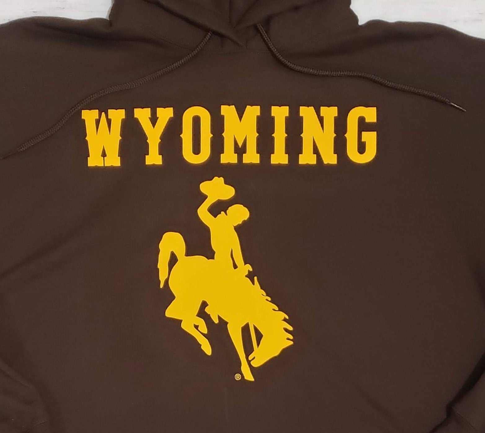 University of Wyoming hoodie with gold bucking horse and "Wyoming" text.