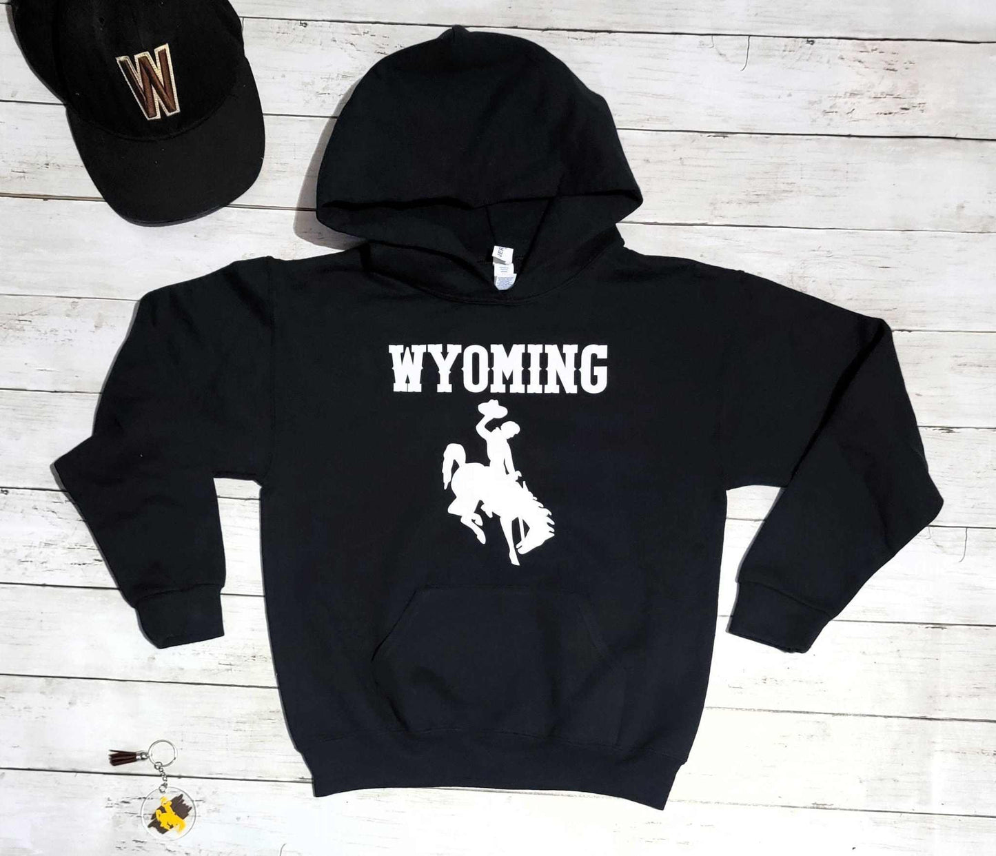 Wyoming Cowboys youth hoodie with bucking horse logo, black sweatshirt, University of Wyoming apparel.