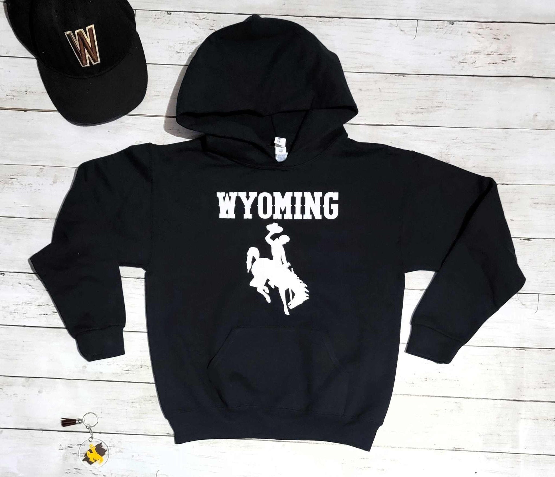Wyoming Cowboys youth hoodie with bucking horse logo, black sweatshirt, University of Wyoming apparel.