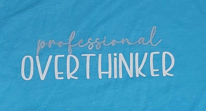 Professional Overthinker shirt in vibrant blue with text design.