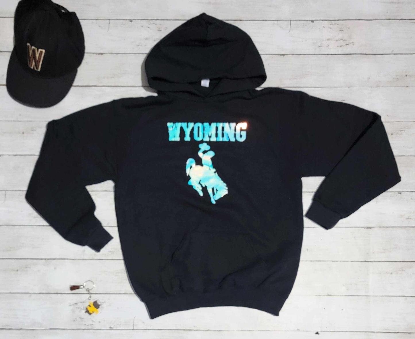 Wyoming Cowboys Youth Apparel black hoodie with bucking horse logo and Wyoming text.