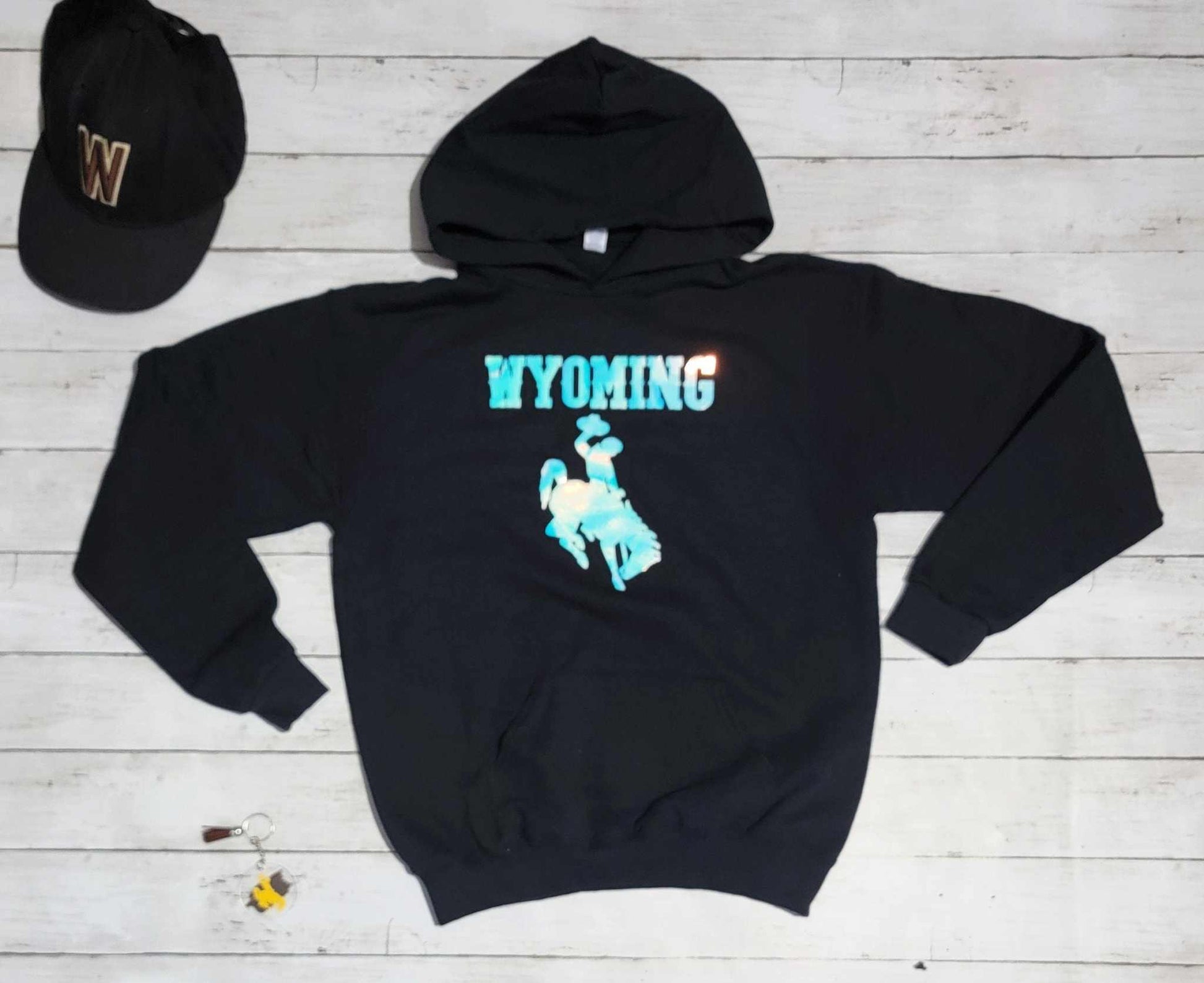 Wyoming Cowboys Youth Apparel black hoodie with bucking horse logo and Wyoming text.