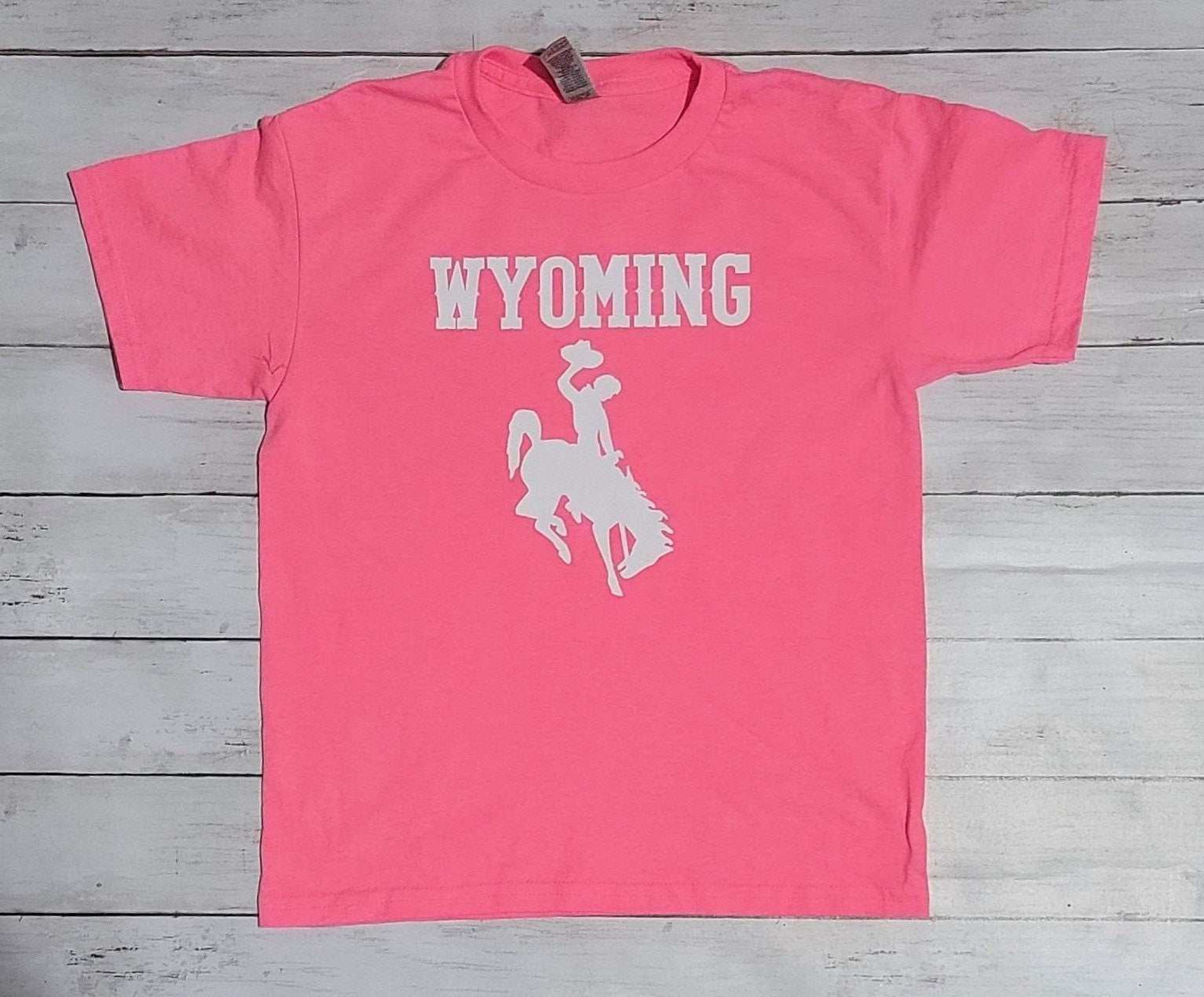Wyoming Cowboys youth apparel pink t-shirt with white cowboy logo.