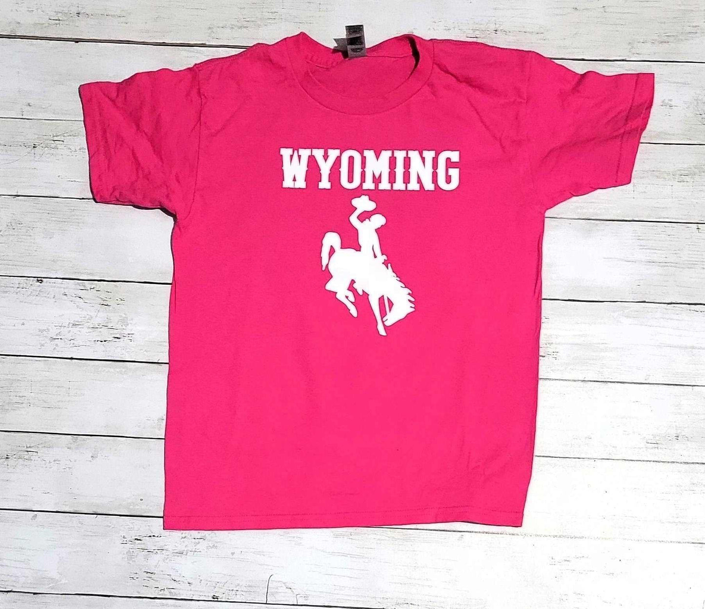 Wyoming Cowboys youth apparel hot pink t-shirt with white logo.