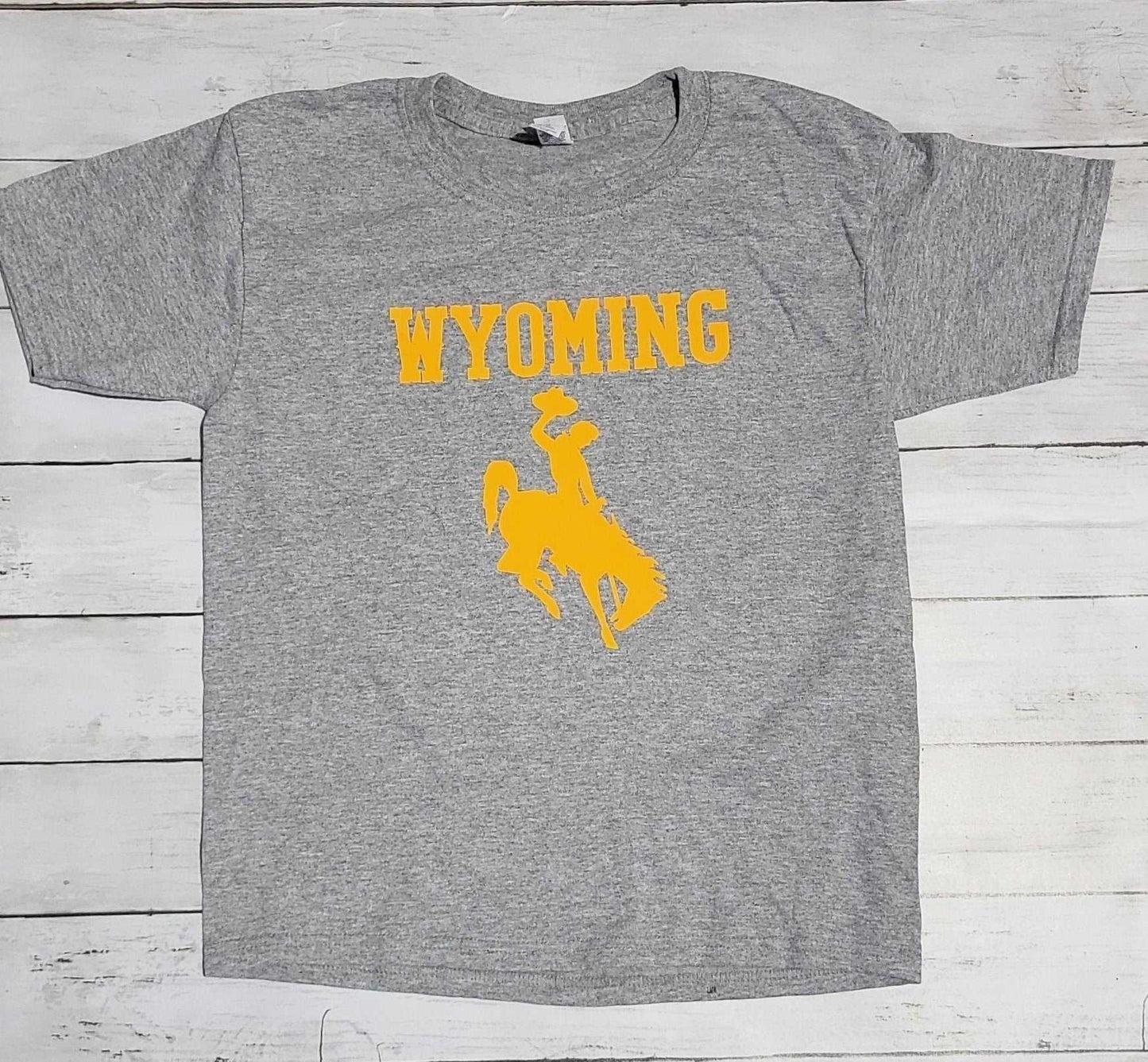 Wyoming Cowboys youth apparel gray t-shirt with yellow cowboy logo.