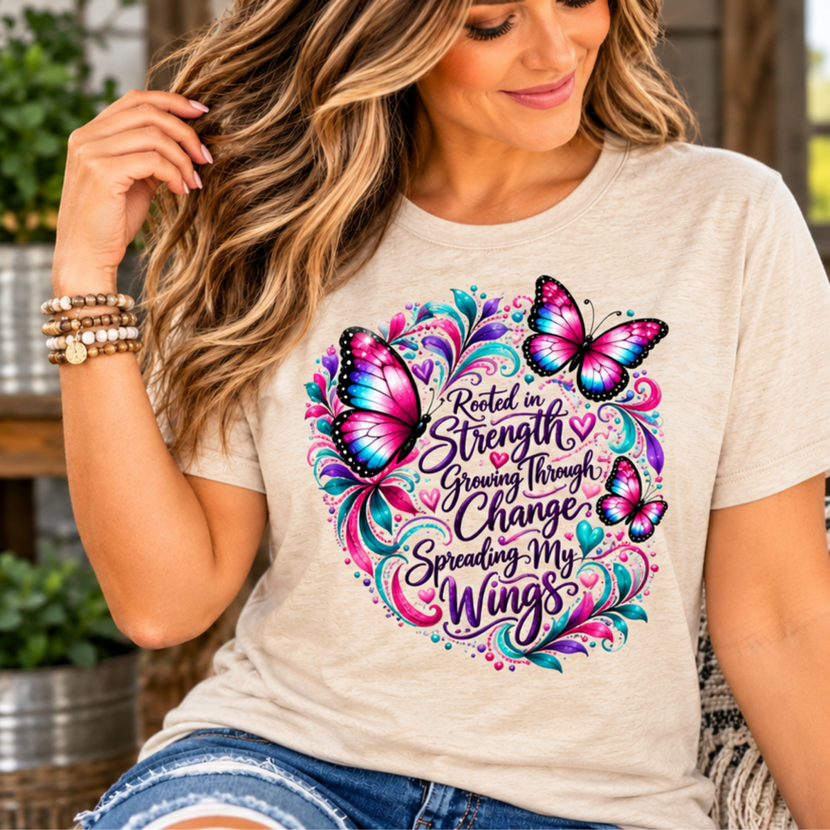 Women's inspirational tshirt design in light heather beige with colorful pink butterflies and a growth-through-change message