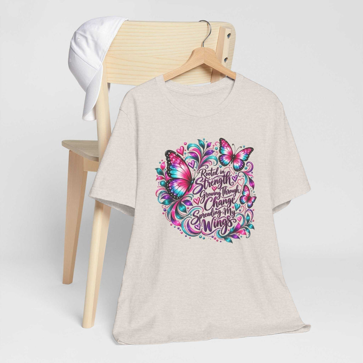 Women's inspirational tshirt design in pale heather beige with colorful butterflies and a message about strength and growth