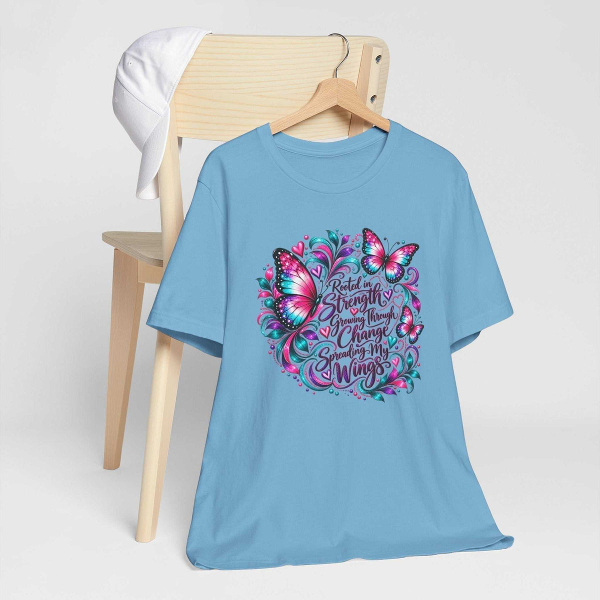 Women's inspirational tshirt design in blue cotton with a colorful butterfly graphic and uplifting growth message