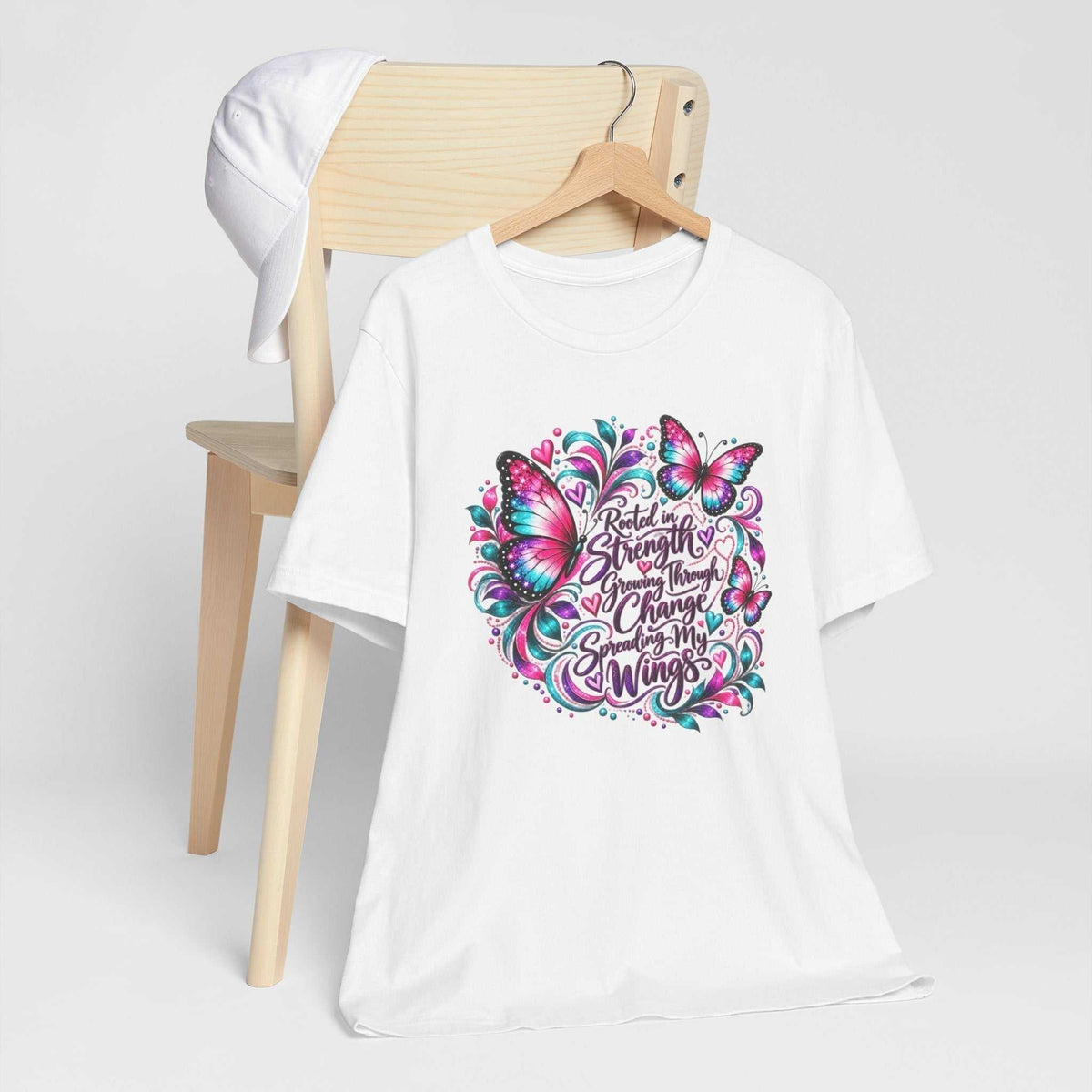 White cotton inspirational tshirt design with colorful pink and teal butterflies and a decorative growth-through-change message