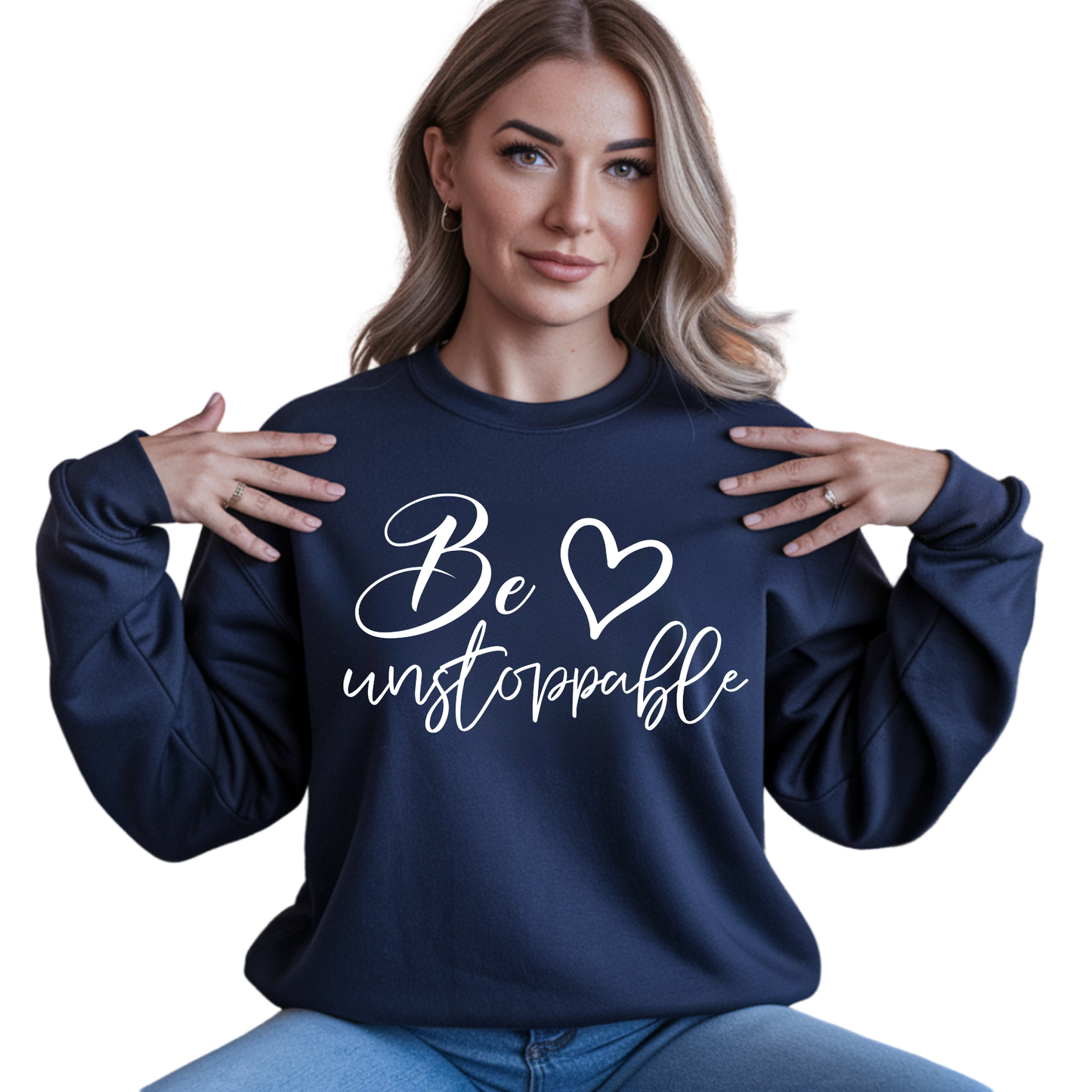 Woman wearing a navy blue sweatshirt with 'Be unstoppable' text