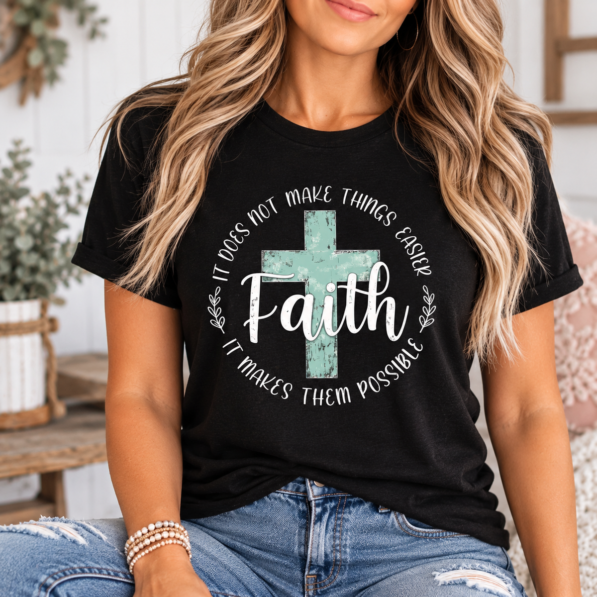 love in faith shirt in black cotton with a distressed turquoise cross and white lettering about faith making things possible