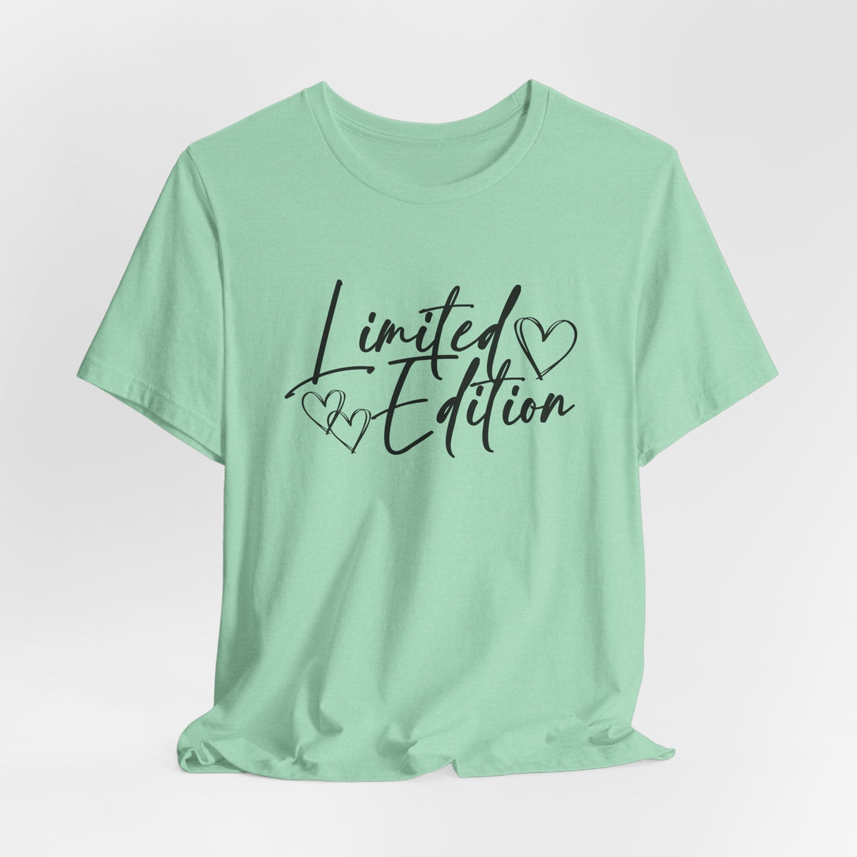 motivational graphic tee in pale mint green cotton with black handwritten “Limited Edition” lettering and outlined hearts