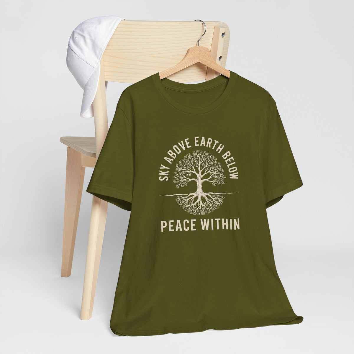 nature inspired tshirt in olive green with a cream rooted tree graphic and “Sky Above Earth Below Peace Within” text
