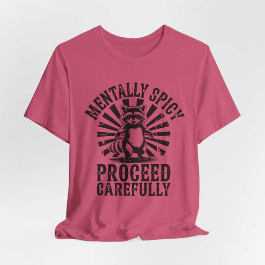 Raccoon tshirt in dusty rose with a black vintage-style raccoon and sunburst graphic reading “Mentally Spicy, Proceed Carefully”