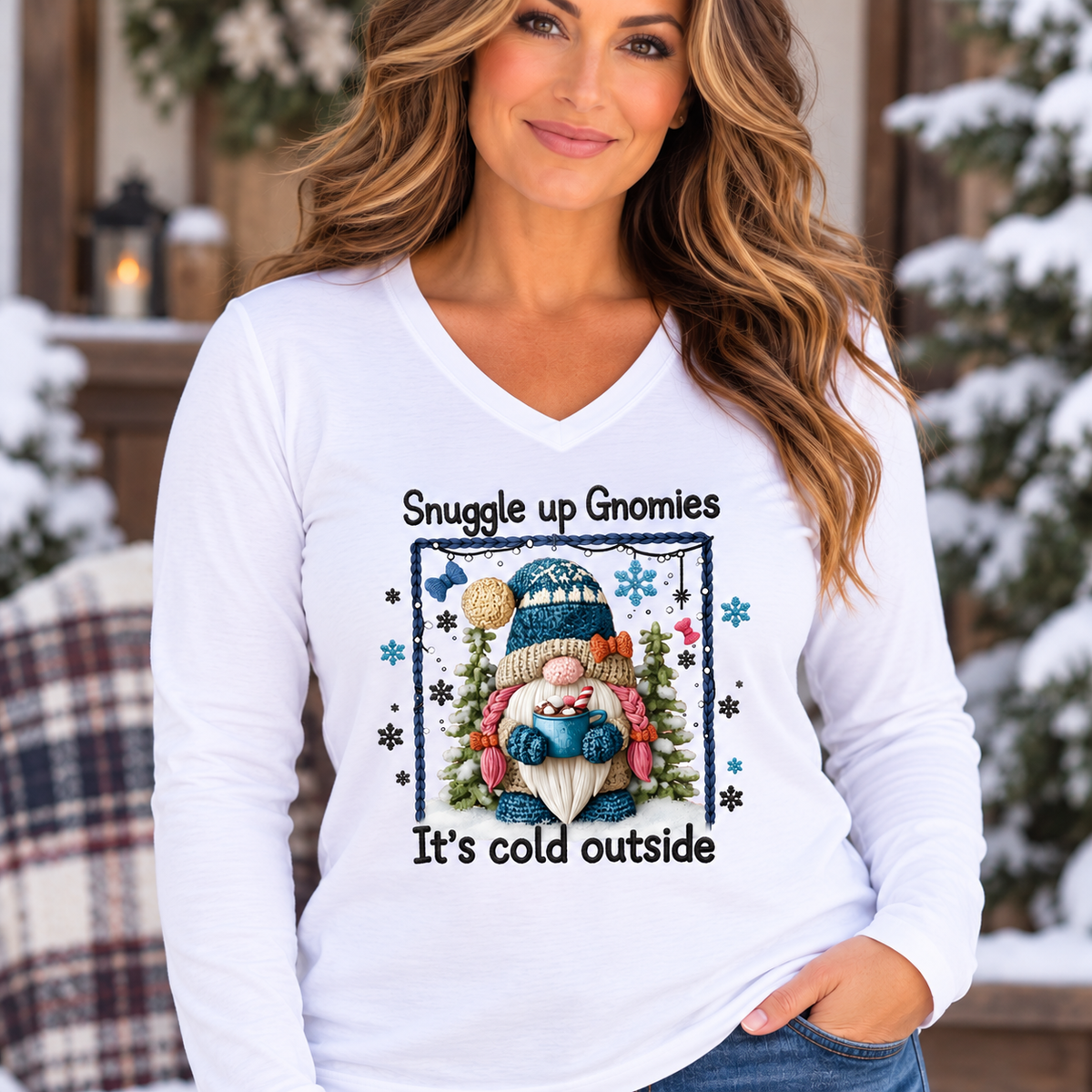 Women’s white long sleeve V-neck tee with a colorful bundled gnome, snowflakes and evergreen print; Snuggle Up With Gnomies