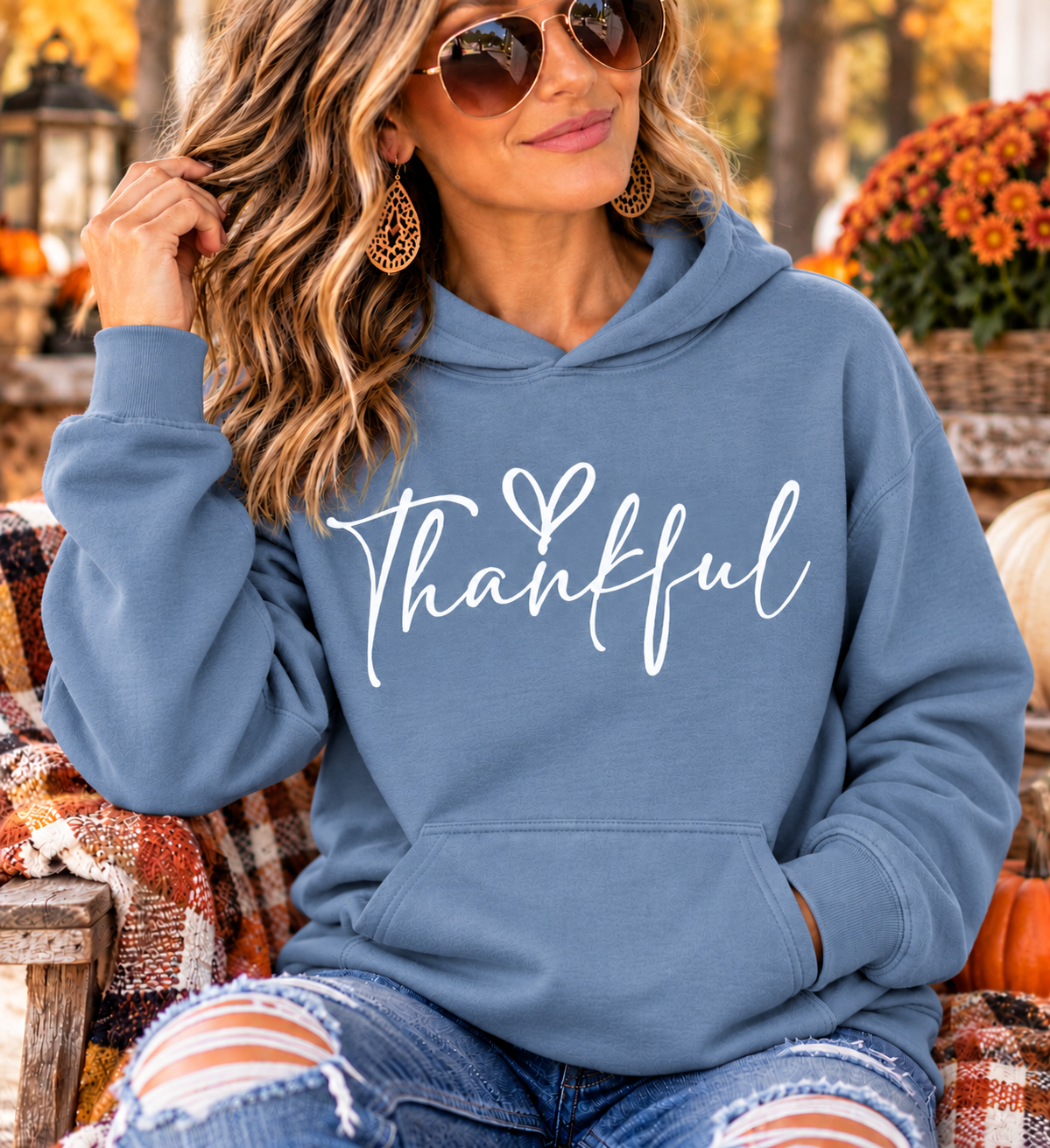 Thankful sweatshirt in dusty blue with white handwritten script lettering and a small heart, featuring a hood and front pouch pocket