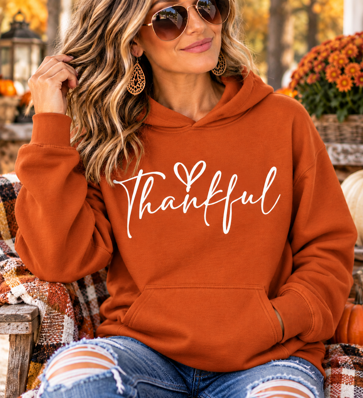 Thankful sweatshirt in rust orange with white handwritten lettering, a small heart, hood and front pouch pocket