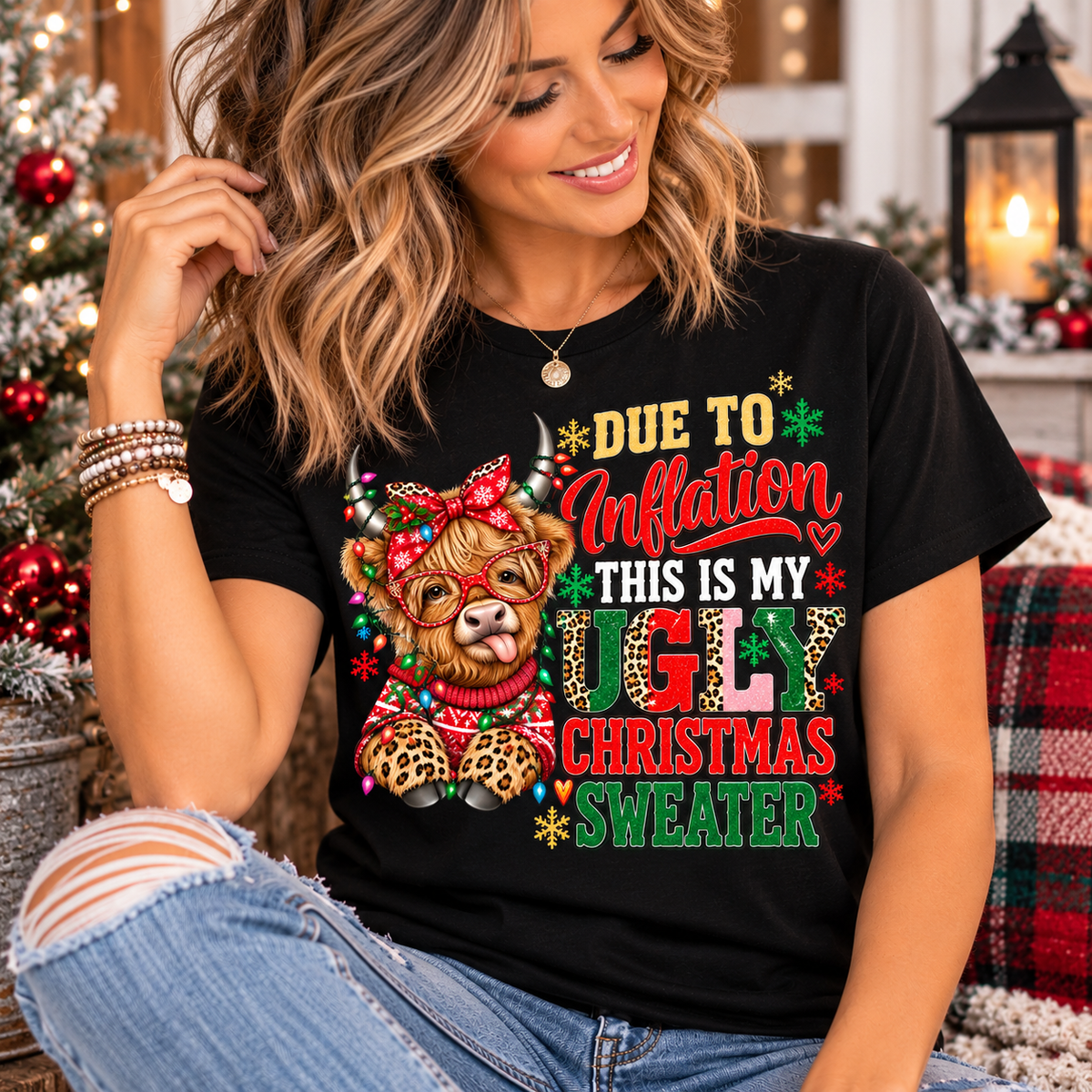 ugly christmas shirt in black cotton with a colorful Highland cow, leopard-print details, festive lights and humorous holiday lettering