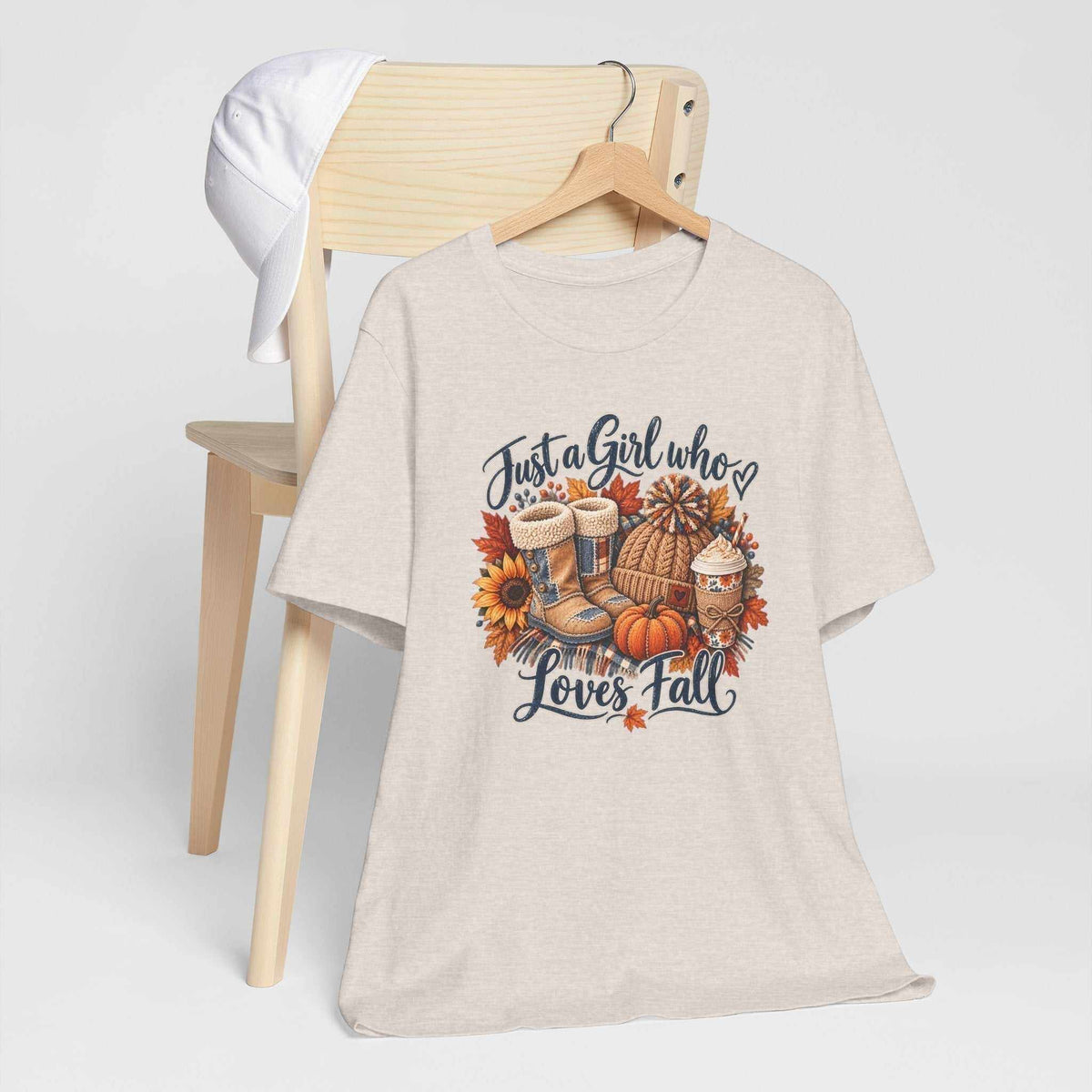 T-shirt for womens fall shirts in light oatmeal fabric with a colorful autumn patchwork graphic of boots, pumpkins, leaves and coffee