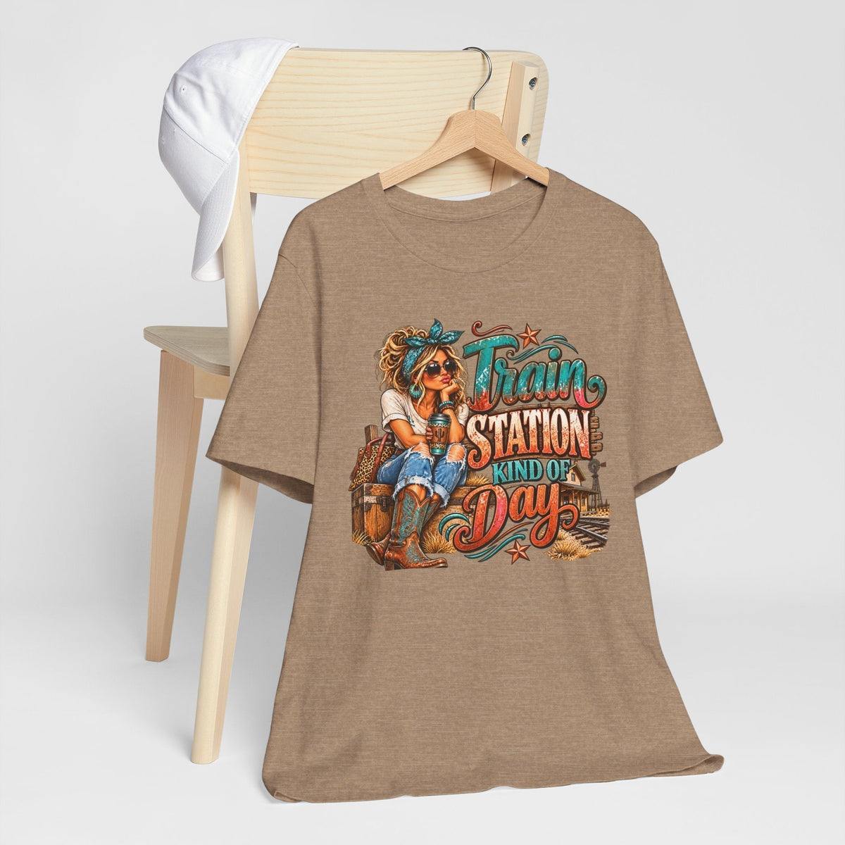 womens western graphic tee in heather brown with a colorful cowgirl and turquoise, rust, and cream railway-themed lettering