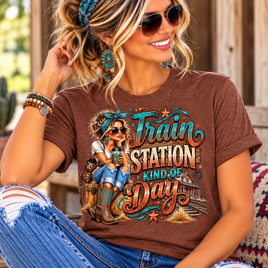 womens western graphic tee in heather brown with colorful turquoise and rust train station lettering and cowgirl artwork