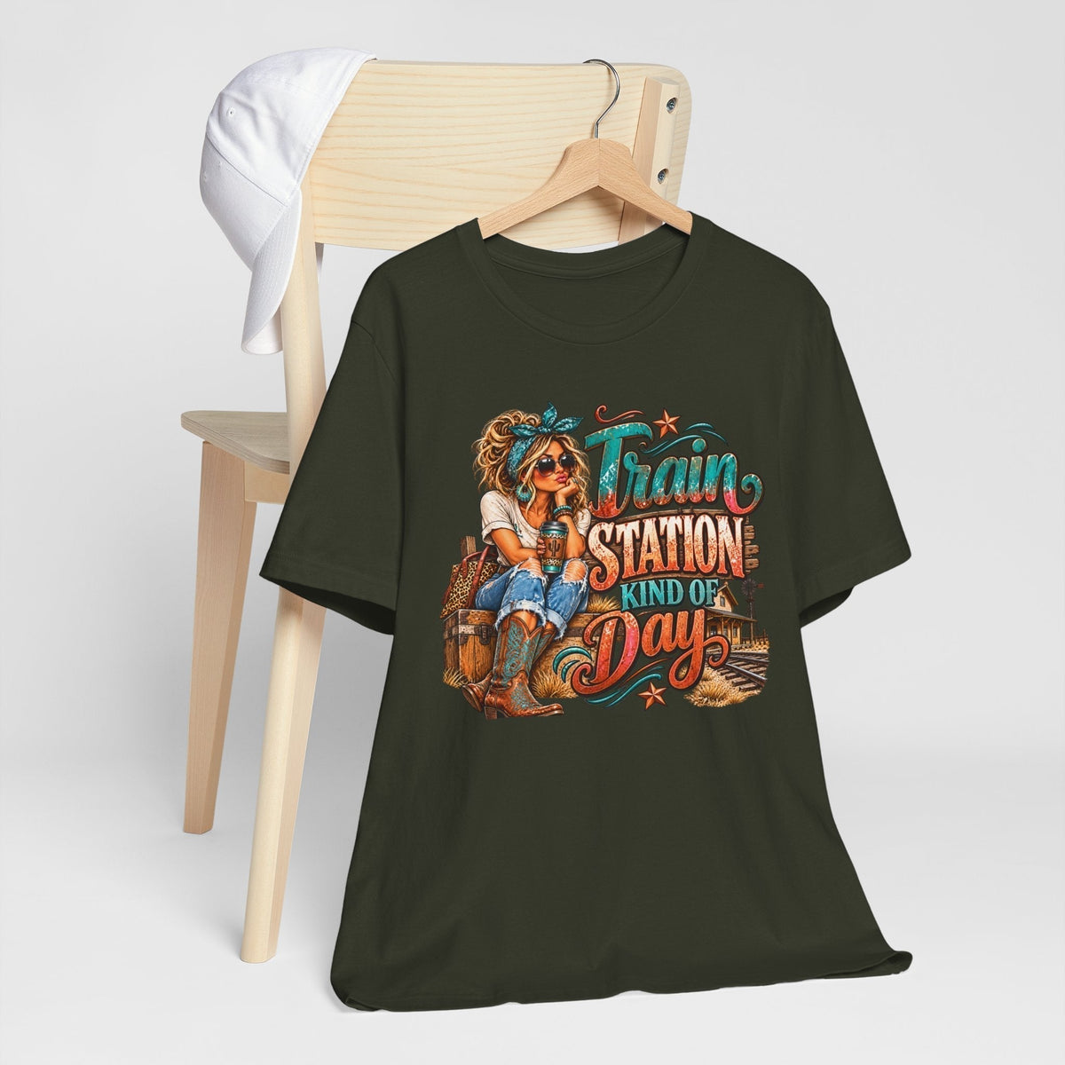 womens western graphic tee in dark olive cotton with colorful turquoise and rust lettering and a seated cowgirl design