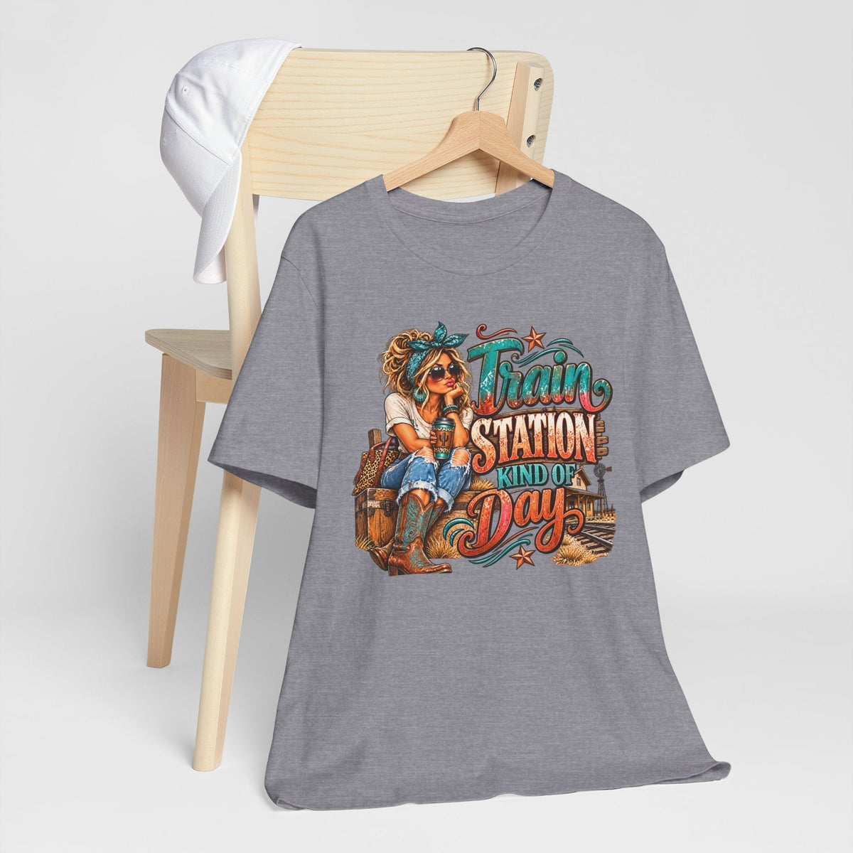 womens western graphic tee in heather gray with a colorful cowgirl, railway scene, and turquoise and rust lettering